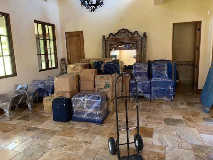 Boxes and furniture carefully packed and wrapped for a Happy Home Movers relocation