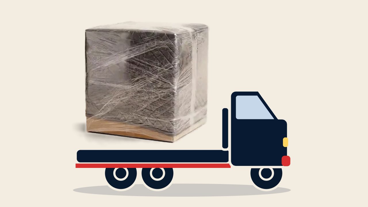 The wrapped, protected box sitting on the deck of a Happy Home Moovers flatbed